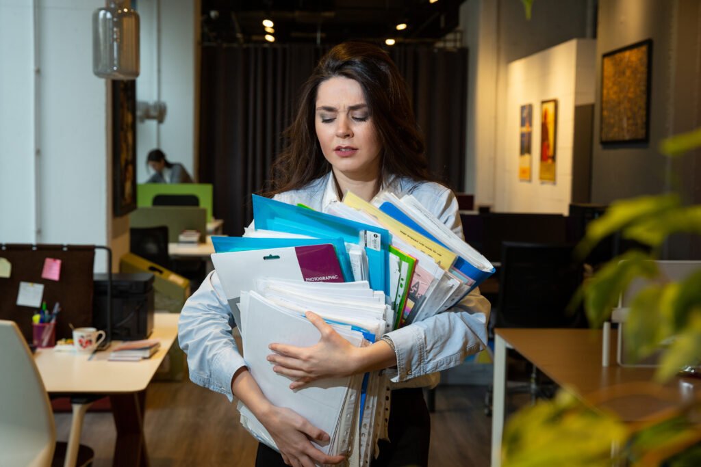 Supervisor searching through a stack of paper travelers for job status